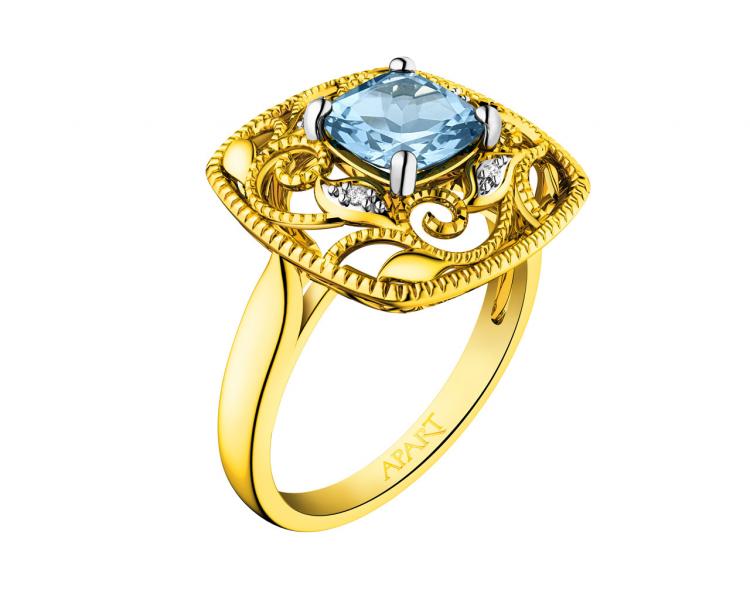 Pierścionek z żółtego złota z diamentami i topazem (London Blue) - próba 585