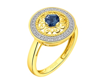 Pierścionek z żółtego złota z diamentami i topazem (London Blue) - rozeta - próba 585