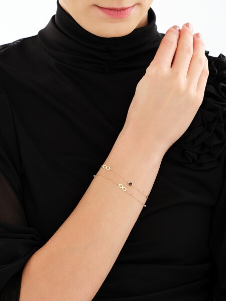 Złota bransoletka z cyrkoniami - nieskończoności